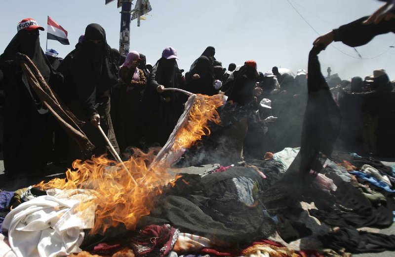 Women in Sana, Yemen, burn their full-body veils, known as makrama, in a protest Wednesday against President Ali Abdullah Saleh’s authoritarian rule. 