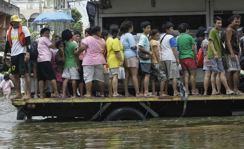 A vehicle evacuates Thai residents from flooded areas of Bangkok on Wednesday. 