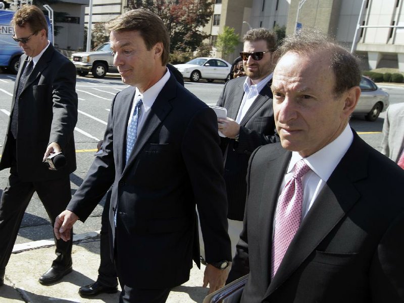 Former U.S. Sen. and presidential candidate John Edwards, center, leaves the federal court after an appearance in Greensboro, N.C., Thursday, Oct. 27, 2011.  A federal judge denied on Thursday a bid by Edwards to have the criminal case against him thrown out, paving the way for a trial to begin in January. (AP Photo/Chuck Burton)