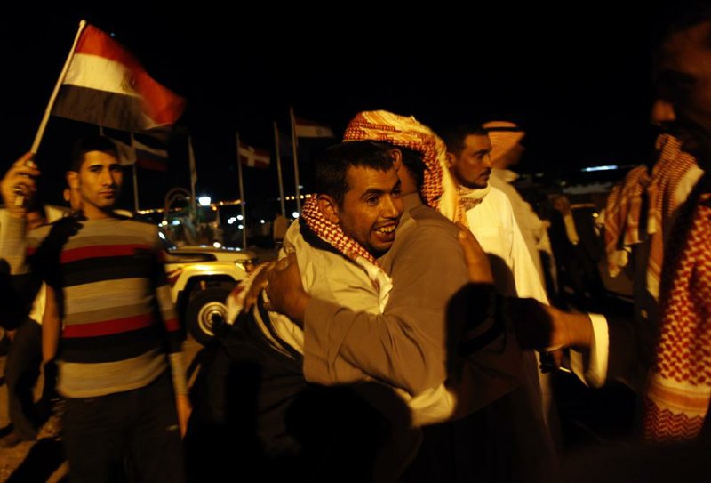 Egyptian released prisoners from Israeli jails , Abdullah Salman, meets his relatives upon his arrival to Egypt at the Taba border crossing in the south of Egypt's Sinai Peninsula, Thursday, Oct. 27, 2011. Twenty-five Egyptians crossed from Israel into Egypt in exchange for a U.S.-Israeli citizen jailed in Cairo on suspicion of espionage. (AP Photo/Khalil Hamra)
