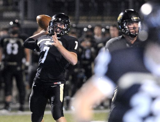 STAFF PHOTO J.S. WEDGEWORTH -- Bentonville's Dallas Hardison throws to a reciever Friday, Oct. 28, 2011, to score a touchdown against Springdale High at Tiger Stadium in Bentonville. 