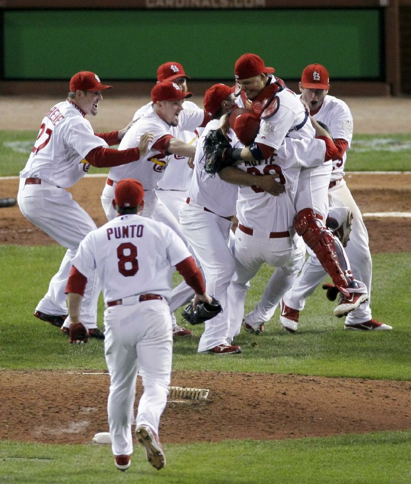 St. Louis Cardinals react after beating the Texas Rangers 6-2 at Game 7 of baseball's World Series Friday, Oct. 28, 2011, in St. Louis. The Cardinals win the series 4-3.  (AP Photo/Jeff Roberson)