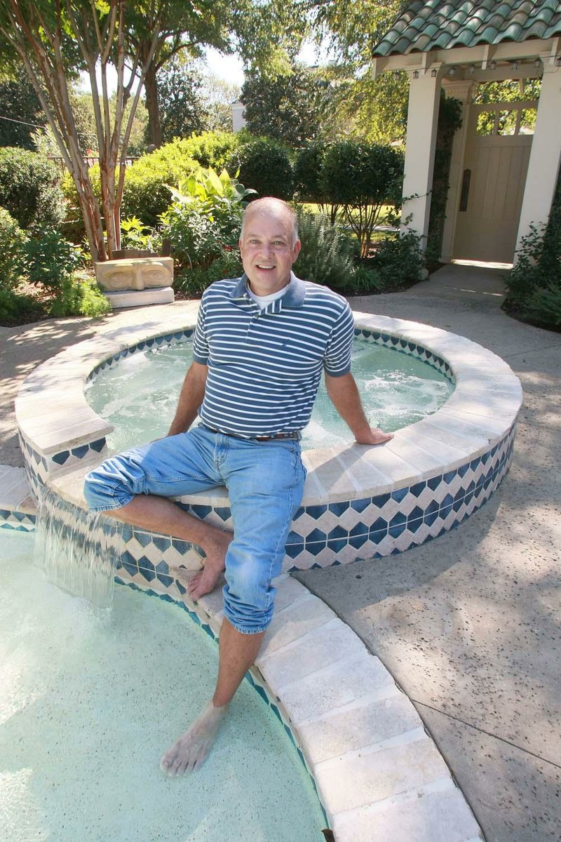 Todd Raney wades in his pool, his favorite space, at his home.