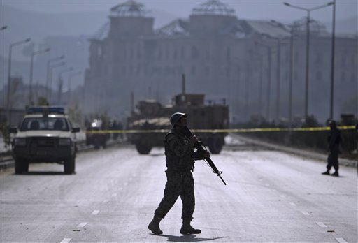 An Afghan national army soldier holds his rifle while seen at the site of a suicide car bomber in Kabul, Afghanistan, on Saturday, Oct. 29, 2011. 