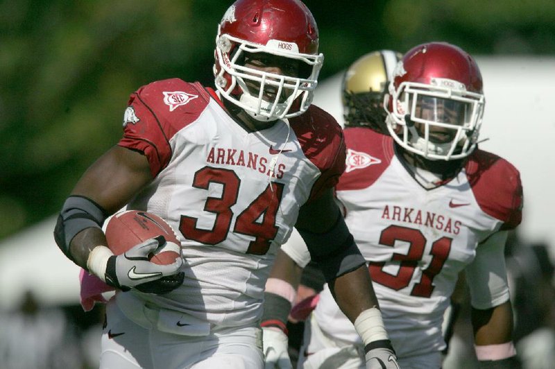 Arkansas linebacker Jerry Franklin (34) sprints toward the end zone, escorted by Jerico Nelson, after recovering a fumble during the fourth quarter of Saturday’s game at Vanderbilt Stadium in Nashville, Tenn. Franklin’s touchdown helped Arkansas tie the score 28-28 and set the stage for Zach Hocker’s winning field goal.