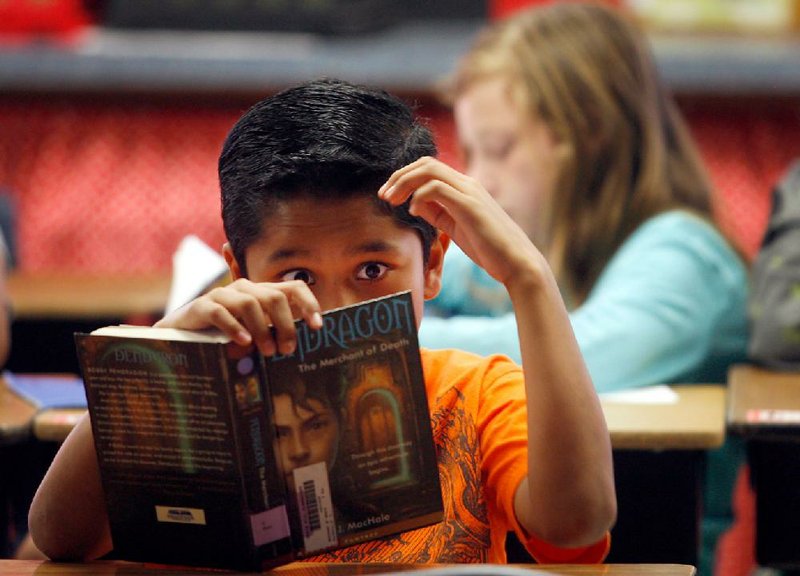 Arkansas Democrat-Gazette/JASON IVESTER --10/06/11--
Grace Hill Elementary fifth-grader Osman (cq) Flores (cq), 10, reads a book during class on Thursday, Oct. 6, 2011, in Rogers.
***for weekend story***