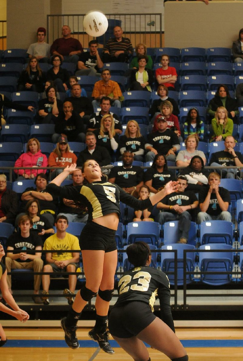 Bentonville’s Shayne Wiedemann jumps to spike the ball in the first game against Fayetteville the final of the Class 7A state championship in Conway. Bentonville won the match 3-1 to secure its second consecutive state championship. 