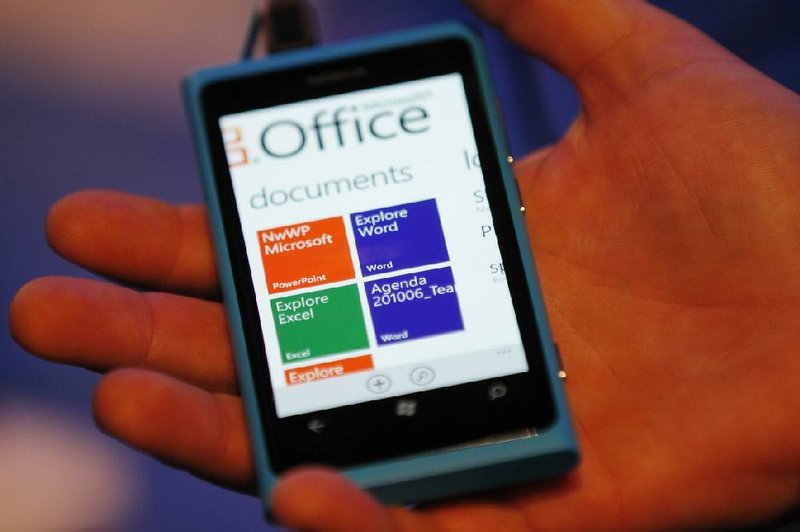 A Nokia employee demonstrates a new Nokia Lumia 800 smart phone during the Nokia World 2011 conference in London last week. 