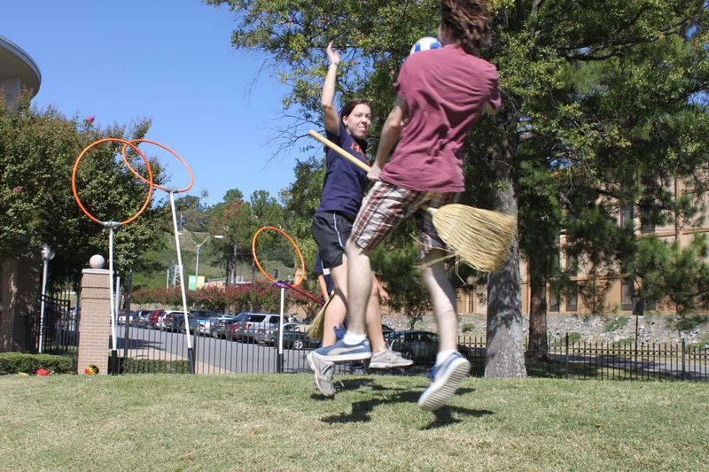 David Harris goes up for a shot as Ashley Gallagher defends in a Quidditch match played recently at Laman Library in North Little Rock.