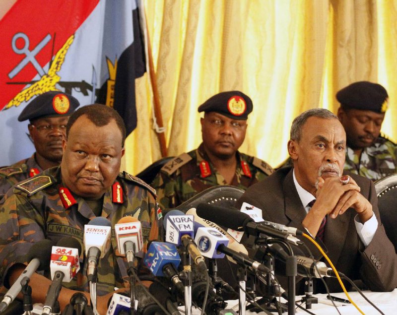 Julius Karangi, Kenyan (CDF) Chief of the Defense Force, left and Defence Minister Yusuf Haji right  speaking to  Journalist at a military press briefing in Nairobi. Kenya .Saturday. Oct.29. 2011. The chief of Kenya's armed forces says Kenyan troops will stay in southern Somalia until Kenyans feel safe again.Gen. Julius Karangi told reporters Saturday that there was no 'timeline' for the Kenyan operation to end. Kenya sent troops into Somalia earlier this month after a string of cross-border attacks and kidnappings.(AP Photo/Khalil Senosi)