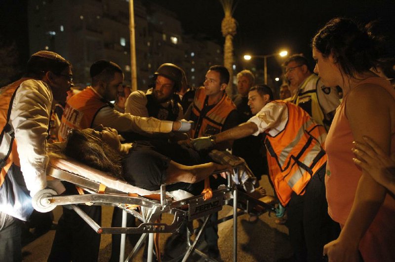 An Israeli woman is evacuated after she was injured in rocket attack in Ashdod, southern Israel, Saturday, Oct. 29, 2011. Israeli aircraft struck at Palestinian militants on Saturday who responded with a volley of rockets which rained on southern Israeli towns, Israeli and Palestinian officials said. (AP Photo / Tsafrir Abayov)