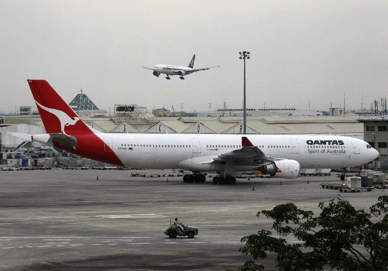 A Qantas Airbus A330 plane sits on the tarmac at Ninoy Aquino International Airport Sunday in Manila, Philippines. The Australian government sought a court order to force the flagship carrier to put its planes back in the air. 