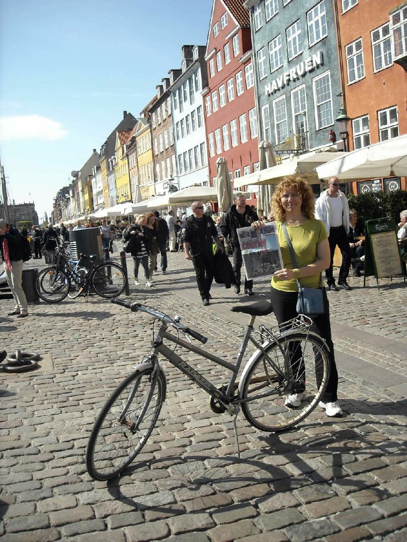 Posing with her bike in Copenhagen, Elinor Warkentin is a frequent solo traveler. On her own in Chile in 1992, she was robbed at knifepoint but learned some valuable lessons about going alone. 