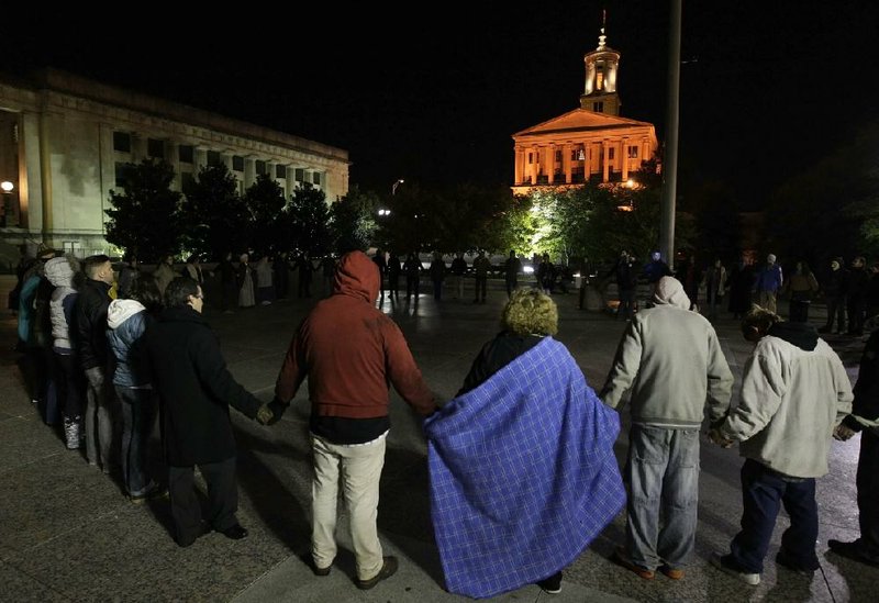 Occupy Nashville protesters join hands Sunday on the Legislative Plaza in Nashville, Tenn. 