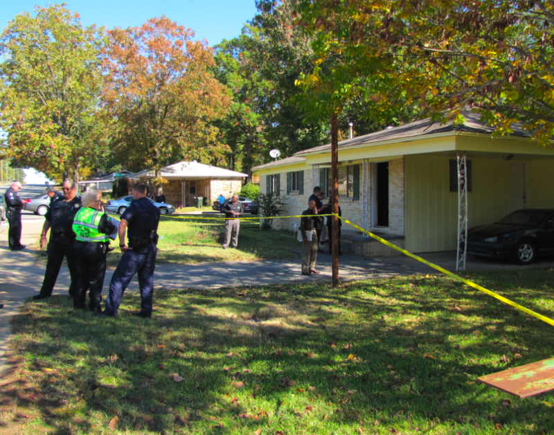 Police work outside 10111 Chicot Road after a shooting there Monday morning.