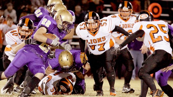 Gravette junior linebacker Peyton Rose puts the stops to a run attempt by Berryville on Friday. Sophomore nose guard Caleb Toney moves in to assist in the take down.