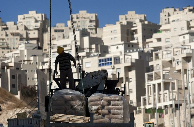 A construction worker tends to a new housing unit in east Jerusalem on Wednesday. 