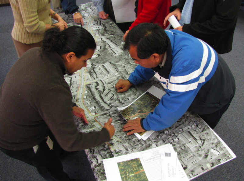 Desiderio Juarez, right, general manager of Casa Manana, looks over design plans for widening Cantrell Road alongside Arkansas Highway and Transportation Department environmental analyst Miguel Mandragon.