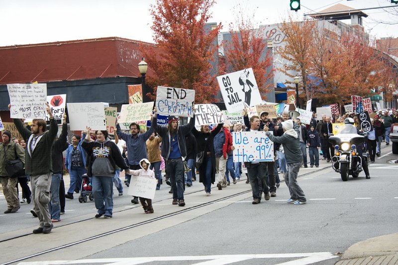 Over 100 Occupy Little Rock protesters marched through downtown Little Rock Saturday, Nov. 5, in support of "Bank Transfer Day."