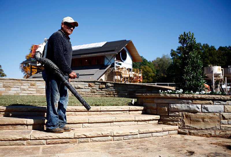  
Andreas Ortiz uses a leaf blower on a memorial site at Pinnacle Memorial Gardens in Rogers on Friday, Oct. 21, 2011.