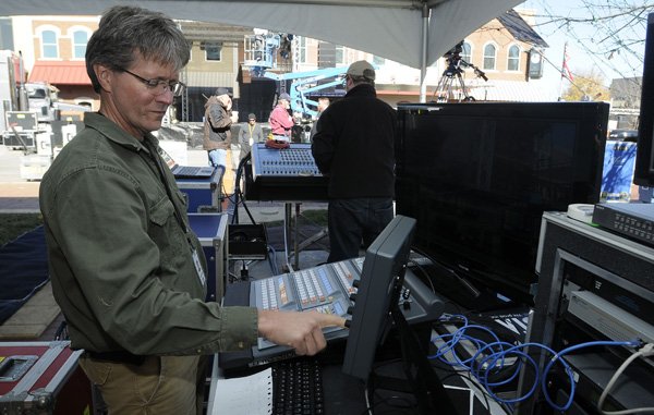 Fran Yount with Vista Productions configures electronics to broadcast and record Thursday while setting up on the Bentonville square for Crystal Bridges’ opening day celebration at 10:30 a.m. today.
