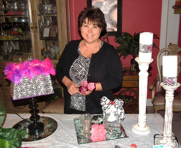 Can you spot the duct tape? Dona Young posses with some of her duct tape creations, including the lamp, picture frame, candle rings and flowers.
