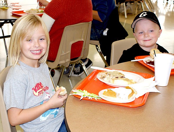 Paige Greer and her brother Peyton enjoyed the Gravette Community Thanksgiving dinner Saturday at the Gravette High School Commons. The children of Mr. and Mrs. Josh Greer, along with their friend Trinity Burnett, were credited with saving the life of an elderly lady who had fallen in her yard near Decatur.