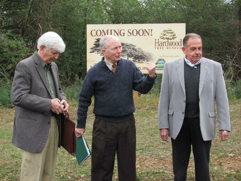 Bob Worley (from left), chairman of the Association of the Hardwood Tree board, University of Arkansas at Fort Smith history professor Billy Higgins and Chaffee Crossing Executive Director Ivy Owen talk Tuesday during an announcement that the assocation is planning a tree museum at Chaffee Crossing.