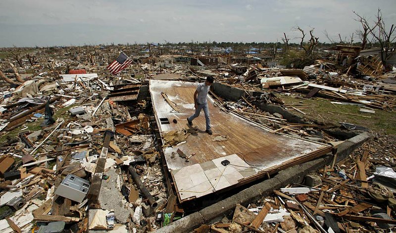  Patrick O'Banion salvages items from his devastated Joplin, Mo. home Monday, May 30, 2011. An EF-5 tornado tore through much of the city May 22, damaging a hospital and hundreds of homes and businesses and killing at least 139 people. 