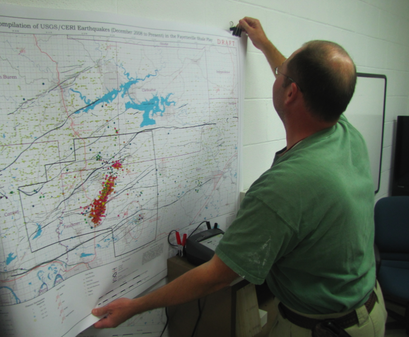 Arkansas Geological Survey geohazards supervisor Scott Ausbrooks puts up a map showing the location of earthquakes in central Arkansas in recent months during a recent interview at his Little Rock office.