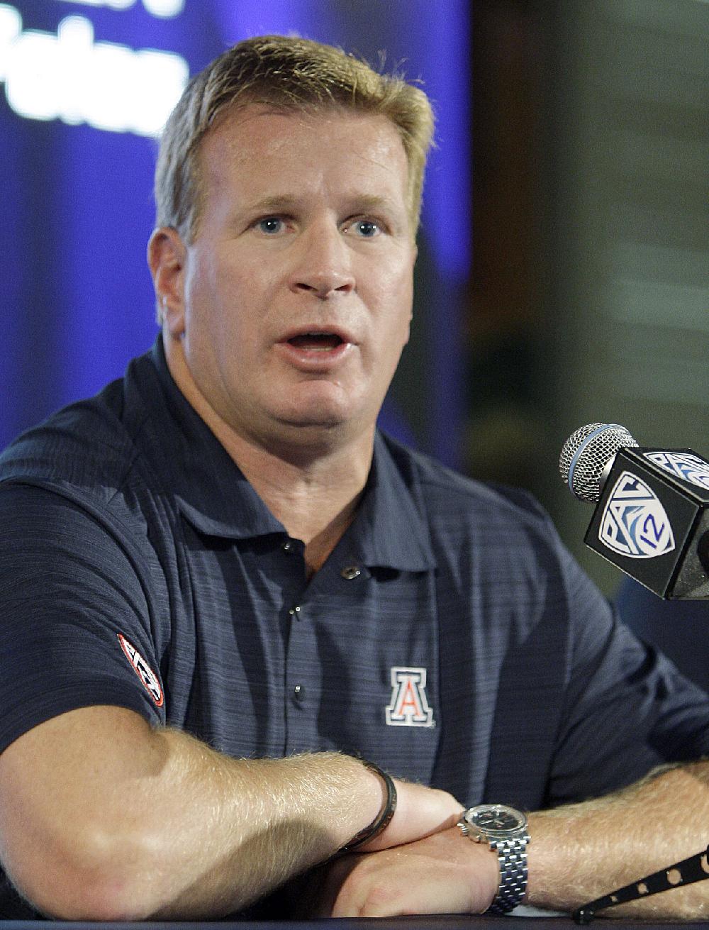 FILE - In this July 26, 2011, file photo, Arizona coach Mike Stoops talks to reporters during the Pac-12 football media day in Los Angeles. Stoops says he would consider the Nebraska defensive coordinator's job if it is offered to him. Huskers coach Bo Pelini has to fill the opening left when his brother, Carl, left to become head coach at Florida Atlantic. (AP Photo/Reed Saxon, File)