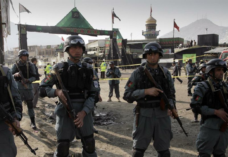Afghan police guard the scene of a suicide attack Tuesday in Kabul that targeted Shiite pilgrims observing Ashoura, the holiest day on the Shiite calendar. 