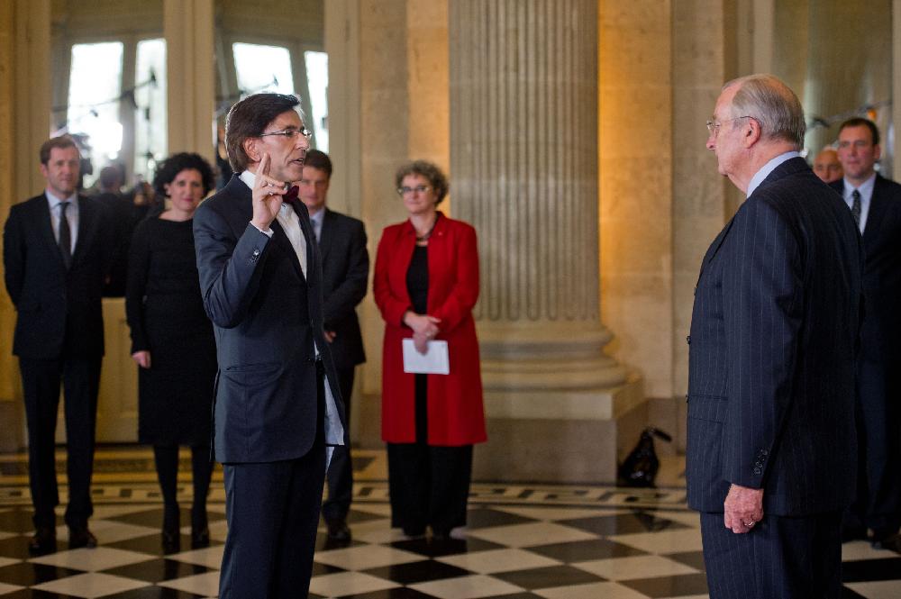 Elio Di Rupo, left, takes the oath during a swearing-in ceremony with Belgian King Albert II, right, as the first French-speaking Belgian prime minister in nearly 40 years, after formally ending the record 541 days the country has gone without a government, at the Royal Palace in laeken, near Brussels, Tuesday, Dec. 6, 2011. The swearing-in is a long-awaited relief to the entire nation of 6.5 million Dutch speakers and 4.5 million French speakers who long ago grew frustrated with the deadlock between politicians over linguistic differences. (AP Photo/Geert Vanden Wijngaert)