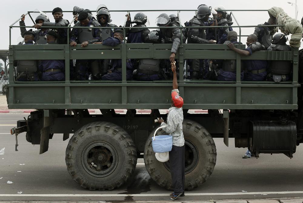 Congolese riot police stands in front of the parliament building in Kinshasa, Democratic Republic of Congo, Monday Dec. 5, 2011. A sense of dread permeated the capital, as citizens awaited the proclamation of results Tuesday Dec 6 2011from Congo's contested presidential ballot, a vote that was supposed to mark another step toward peace but which instead could be a flashpoint for more violence.(AP Photo/Jerome Delay)