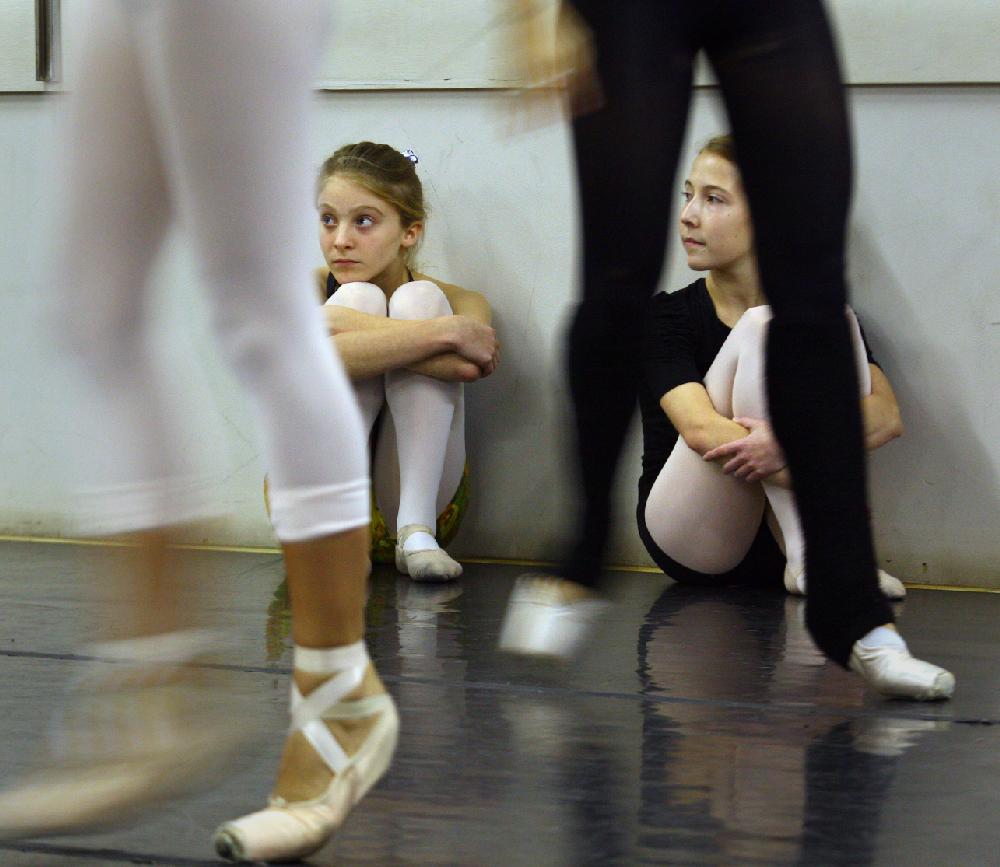 11/20/11
Arkansas Democrat-Gazette/STEPHEN B. THORNTON
Lauren-Frances Wood, 12, left, and Kathryn Latham, 14, watch from the sidelines as a large group of performers rehearse  Ballet Arkansas' The Nutcracker Sunday afternoon at Shuffles & Ballet II in Little Rock. The girls will alternate playing the role of Clara in the ballet.