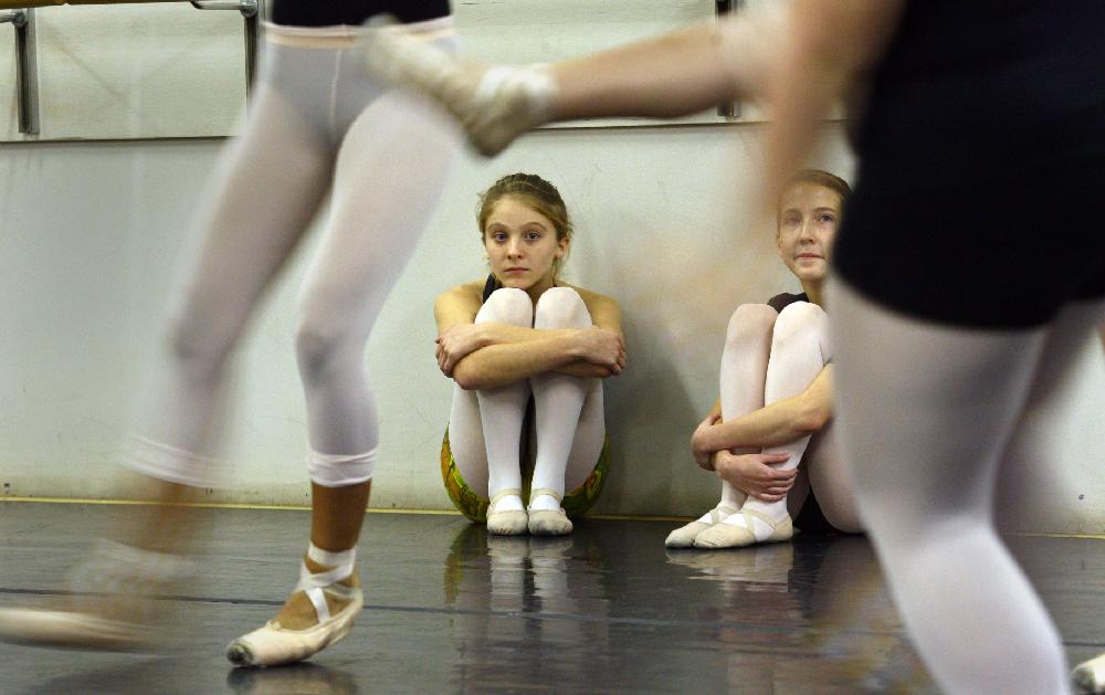11/20/11
Arkansas Democrat-Gazette/STEPHEN B. THORNTON
Lauren-Frances Wood, 12, left, and Kathryn Latham, 14, watch from the sidelines as a large group of performers rehearse  Ballet Arkansas' The Nutcracker Sunday afternoon at Shuffles & Ballet II in Little Rock. The girls will alternate playing the role of Clara in the ballet.