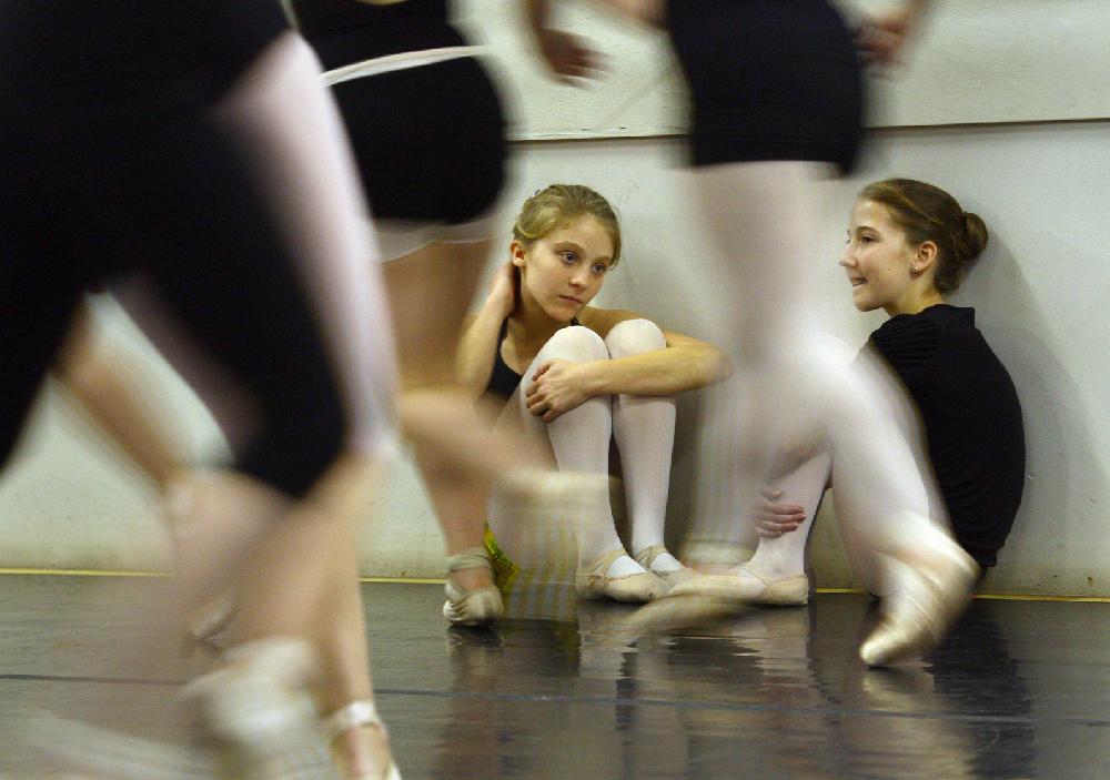 11/20/11
Arkansas Democrat-Gazette/STEPHEN B. THORNTON
Lauren-Frances Wood, 12, left, and Kathryn Latham, 14, watch from the sidelines as a large group of performers rehearse  Ballet Arkansas' The Nutcracker Sunday afternoon at Shuffles & Ballet II in Little Rock. The girls will alternate playing the role of Clara in the ballet.