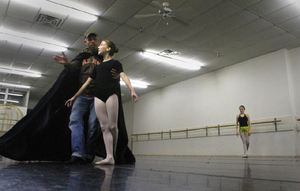 11/20/11
Arkansas Democrat-Gazette/STEPHEN B. THORNTON
Stephen Stone, left, who plays the role of Herr Drosselmeyer works with Kathryn Latham, 14, as Lauren-Frances Wood, 12, right, waits her turn to work on the move  during rehersal for  Ballet Arkansas' The Nutcracker Sunday afternoon at Shuffles & Ballet II in Little Rock. The girls will alternate playing the role of Clara in the ballet.
