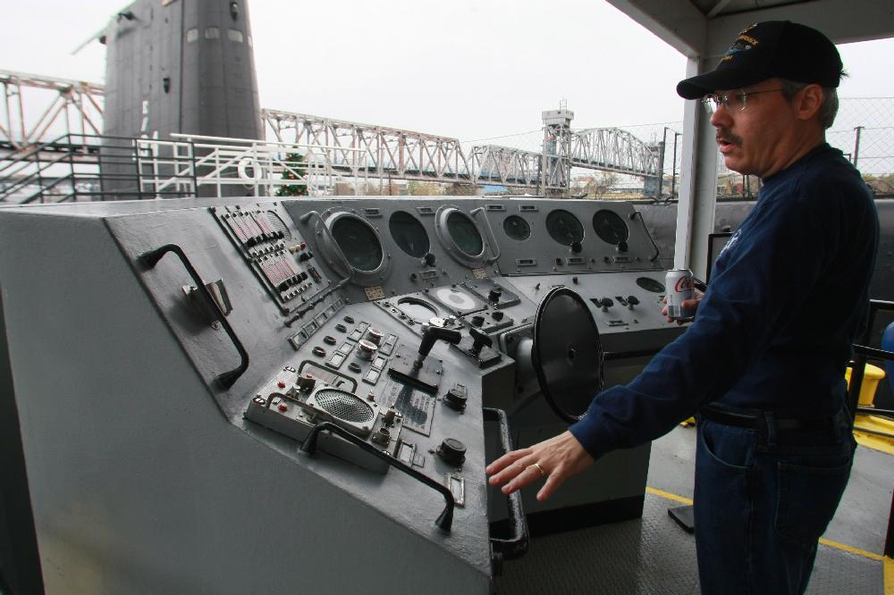 Arkansas Democrat-Gazette/RICK MCFARLAND --12/06/11-- Greg Stitz explains what the controls are for on the helm station that was used on the USS Arkansas when it was decommissioned in 1998. The Arkansas was a nuclear-powered guided missile cruiser built in 1980. Stitz was getting things ready Tuesday at the Arkansas Inland Maritime Museum in North Little Rock for a ceremony to be held Wednesday in honor of the 70th anniversary of the Jappanese attack on Pearl Harbor. During the ceremony an update will be given on the transportation of the Hoga, a tugboat that was damaged but survived the attack 70 years ago.