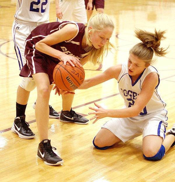 Lauren Little of Gentry struggles to retain possession of the ball against a Rogers player on Nov. 29 in the Benton County Junior High Tournament held at Gentry.
