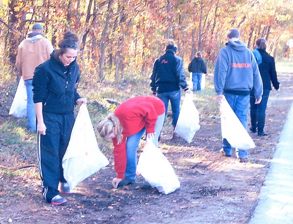 Katlynn Martin and Brooke Belts pick up trash at the Mt. Pleasant Cemetery. 