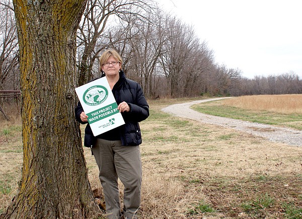 Allyson Ransom, who wrote the grant request for the Pop Allum Park trail, stands near where the new trailhead will be located. The existing trail, shown in the photo along with a connecting loop, will be upgraded and paved.
