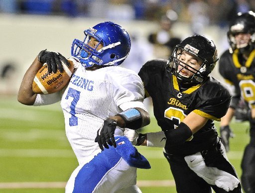 Strong running back Kenneth Dixon evades a Carlisle defender in the Class 2A title game. Dixon finished the game with 348 yards and broke the state single-season rushing record in the game.