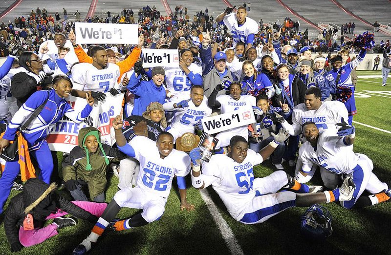 Strong players, coaches, cheerleaders and fans celebrate after the Bulldogs’ 45-20 victory over Carlisle on Saturday night in the Class 2A championship game at War Memorial Stadium in Little Rock. 
