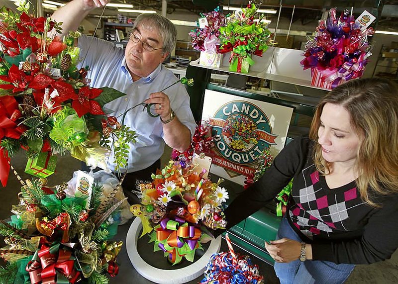 Candy Bouquet Chief Executive Jim Wheeler and owner Janet Wheeler build bouquets at company headquarters in Little Rock. 