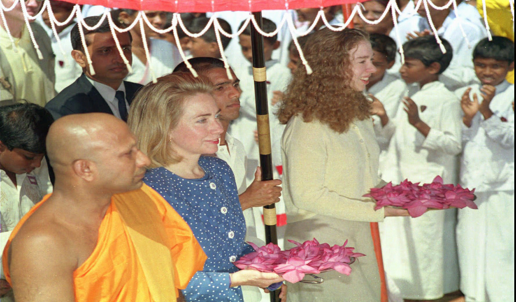 1995 | First lady Hillary Rodham Clinton and her daughter Chelsea, right, carry trays of flowers to offer at a Buddhist temple in Colombo.