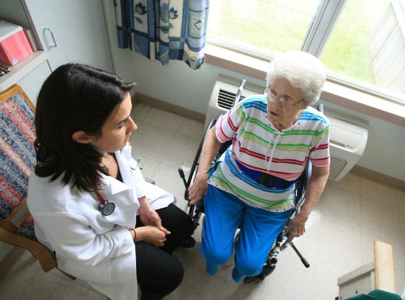 Arkansas Democrat-Gazette/fSTATON BREIDENTHAL 8/10/11
Certified physicians' assistant Lindsay Hayward (left) talks with patient Lucy Hatton while visiting her room at Premier Health Care Nursing Home in North Little Rock.