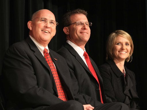 New Arkansas State University football coach Gus Malzahn (middle) with his wife Kristi and ASU Athletic Director Dean Lee during Malzahn's introductory press conference in Jonesboro. Lee was reportedly reassigned within the university on Tuesday.