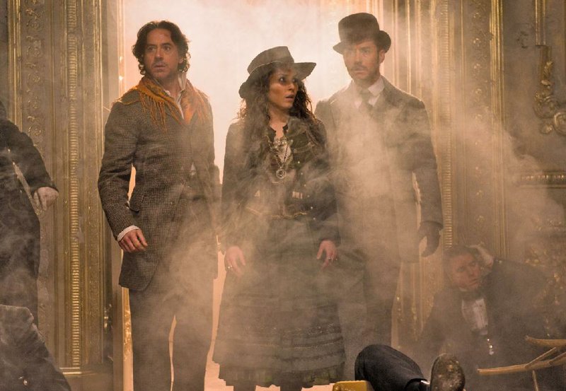 Madam Simza (Noomi Rapace) enlists Sherlock Holmes (Robert Downey Jr.) and Dr. James Watson (Jude Law) in her search for her anarchist brother in Guy Ritchie’s Sherlock Holmes: A Game of Shadows. 
