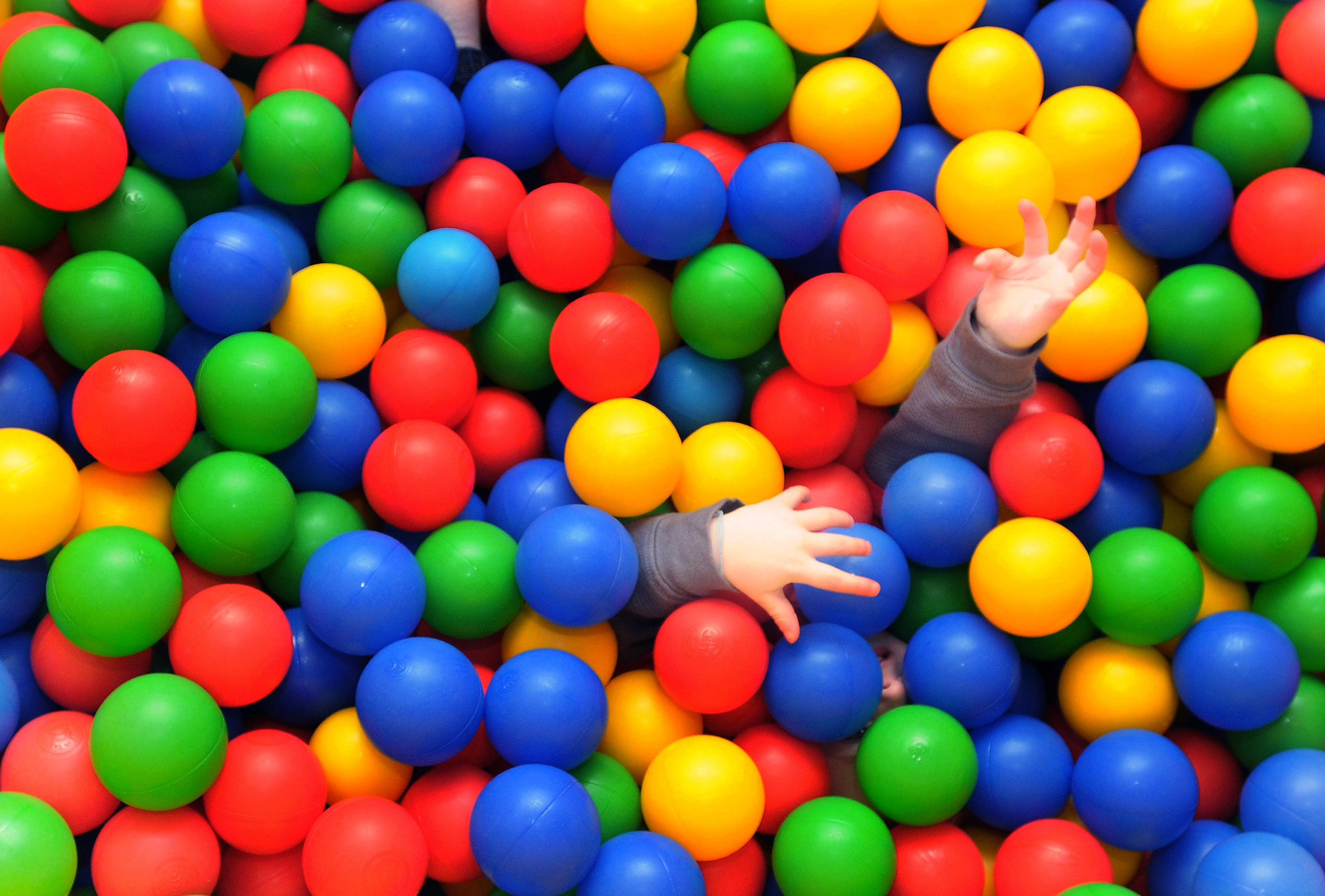 A child reaches up after burying himself in the ball pit Wednesday, Nov. 30, 2011, in the gross motor skills room at the Northwest Arkansas Children's Shelter in Bentonville. Due to the the shelter's capacity size and because the shelter can keep family groups together, the shelter has had requests for placement by 70 out of 75 counties in Arkansas, despite primarily serving children in Benton, Washington, Madison and Carroll counties.